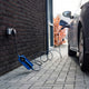 Voldt® Type 1 Portable Charger plugged into an outdoor socket beside a parked car